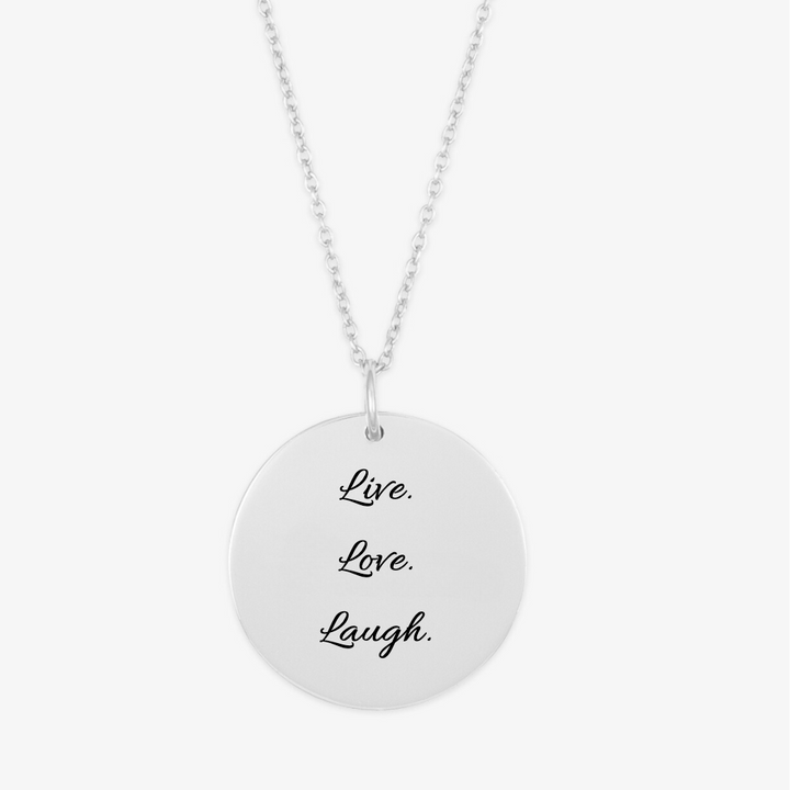 Personalized round medallion pendant necklace in sterling silver with 'Live. Love. Laugh.' engraving on a chain.