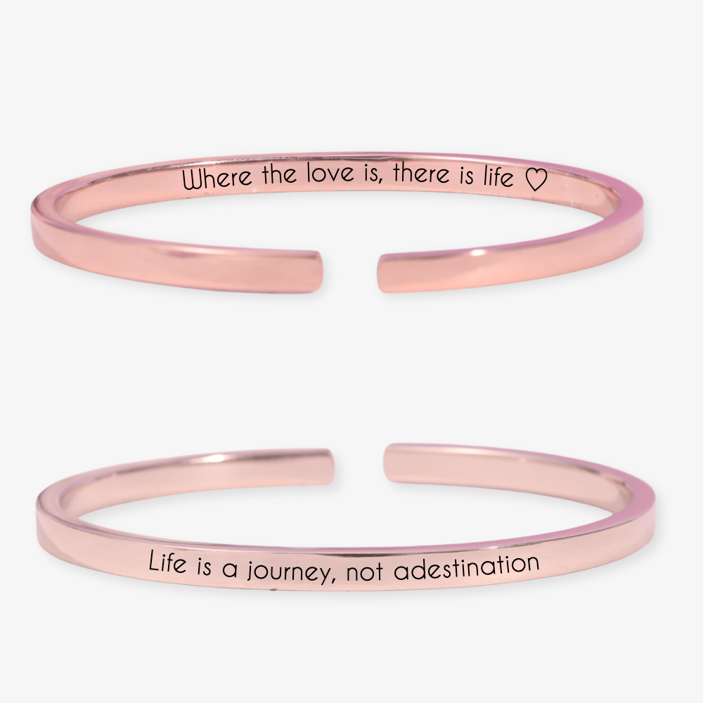 Dual-sided thin engraved bracelet in rose gold with personalized messages, "Where the love is, there is life" and "Life is a journey, not a destination."