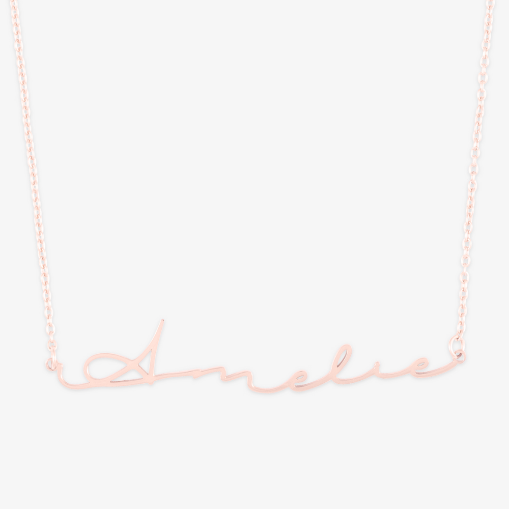 Signature script name necklace in 14 karat gold featuring 'Amelie' on a delicate chain.