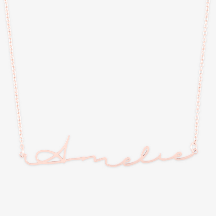 Signature script name necklace in 14 karat gold featuring 'Amelie' on a delicate chain.