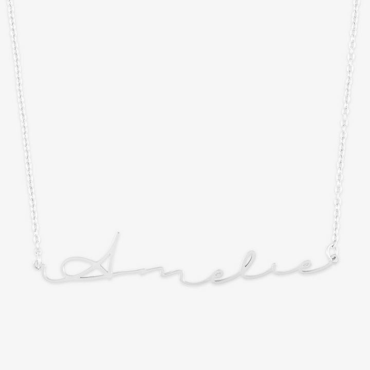 Sterling silver necklace with "Amelie" in elegant signature script font. Unique name jewelry for everyday wear.