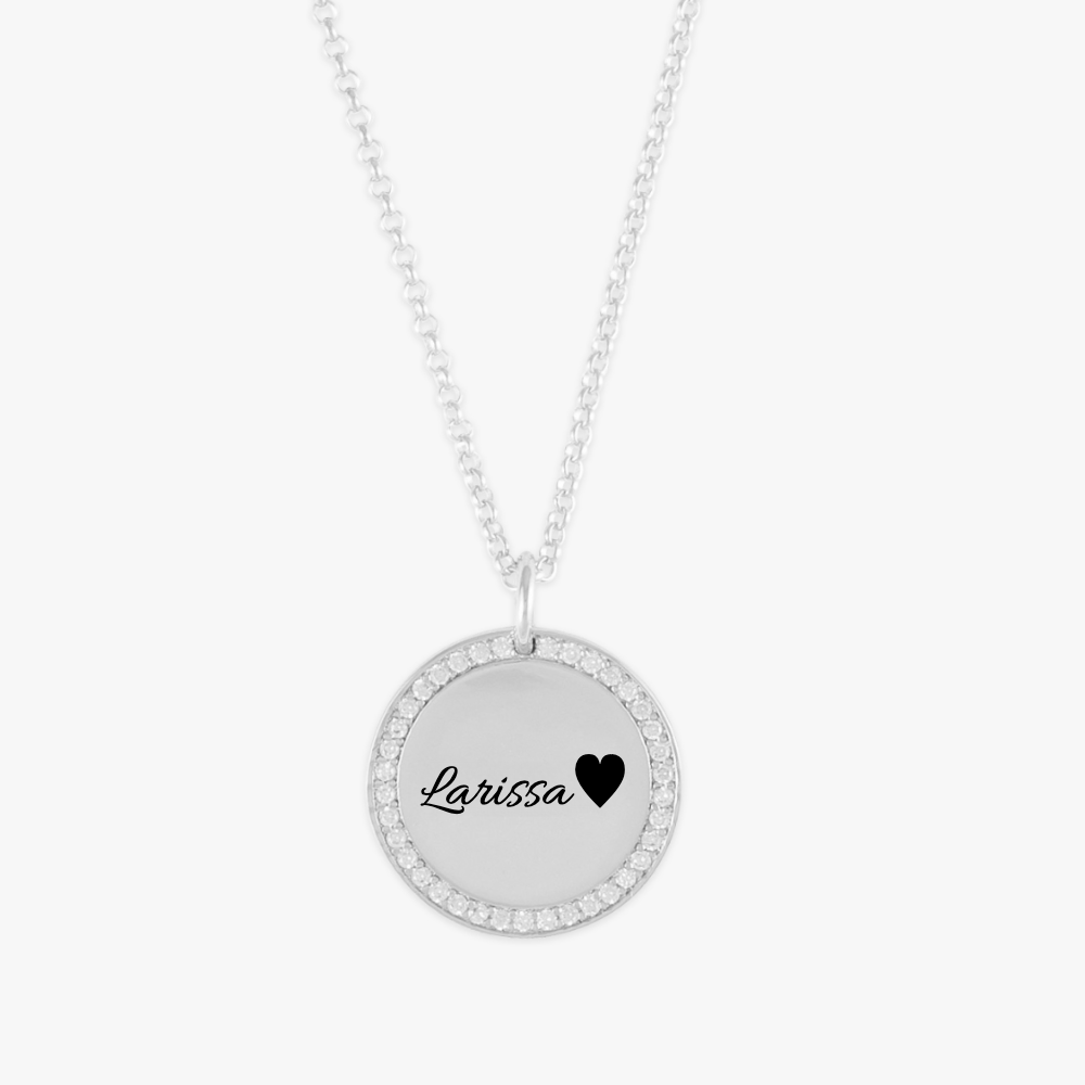 Crystal-encrusted name medallion necklace with customizable sterling silver pendant and cubic zirconia crystals highlighting the edges