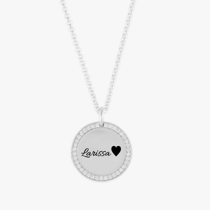 Crystal-encrusted name medallion necklace with customizable sterling silver pendant and cubic zirconia crystals highlighting the edges