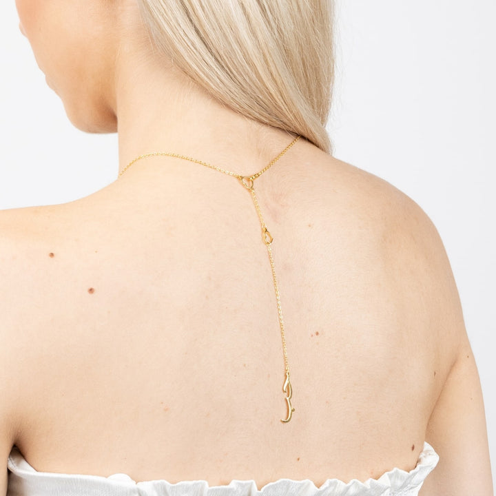 Gold Sabr Hub Arabic Necklace displayed on a woman's back, symbolizing patience and love, made of 14 Karat Gold.