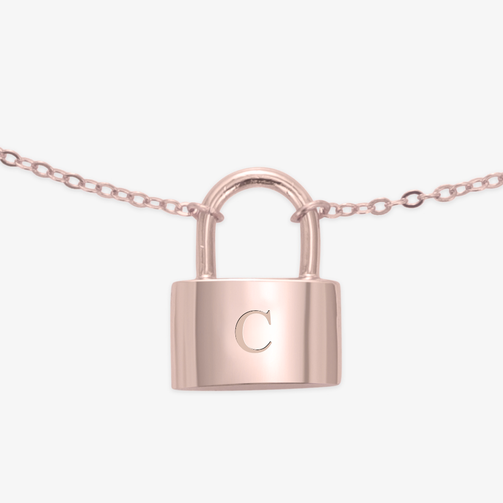 Elegant lock initial necklace with a delicate padlock engraved with the letter "C" in Times New Roman font, attached to a dainty chain.