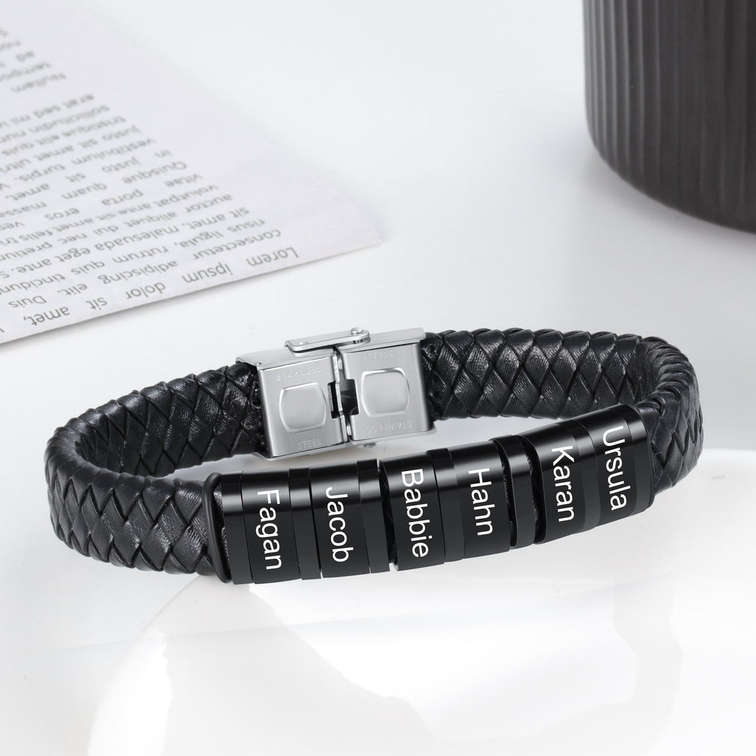 Customizable men's leather bracelet with six engravable rings in black on a woven faux leather strap.