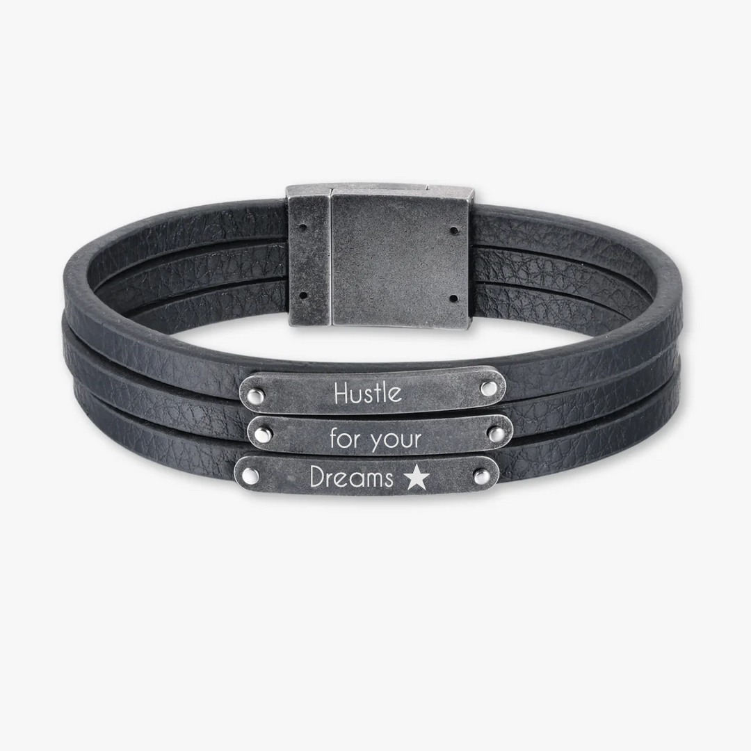 Customizable dark grey leather bracelet with three engravings, featuring "Hustle for your Dreams" text.