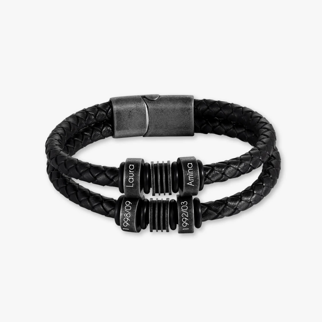 Black braided leather bracelet with stainless steel clasp and four customizable engravings displayed on round charms