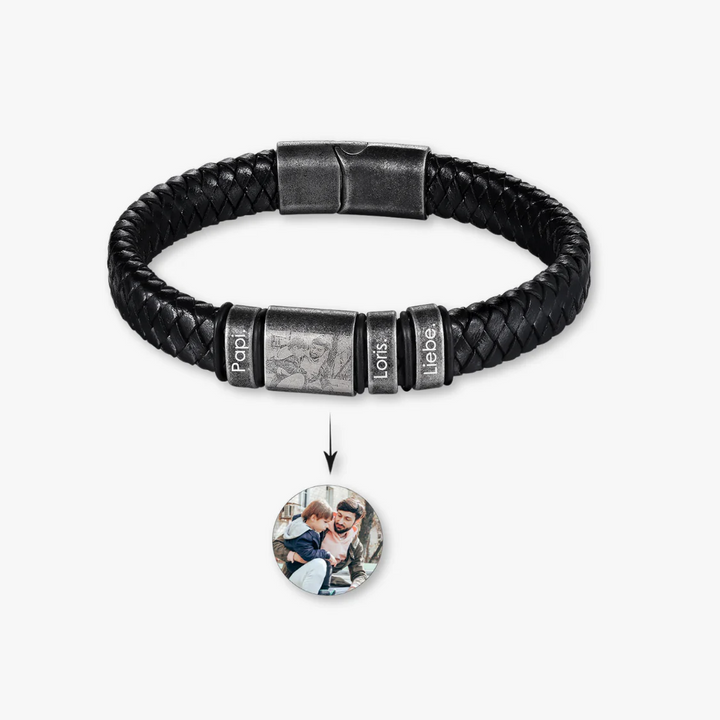 Custom black leather bracelet with three engravings and a photo insert displaying a personalized image.