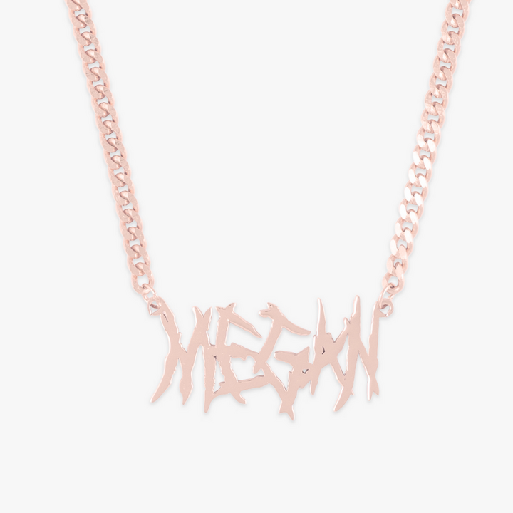 Rose gold heavy metal name necklace with wide link curb chain showcasing the name "Megan" in bold, rebellious letters.