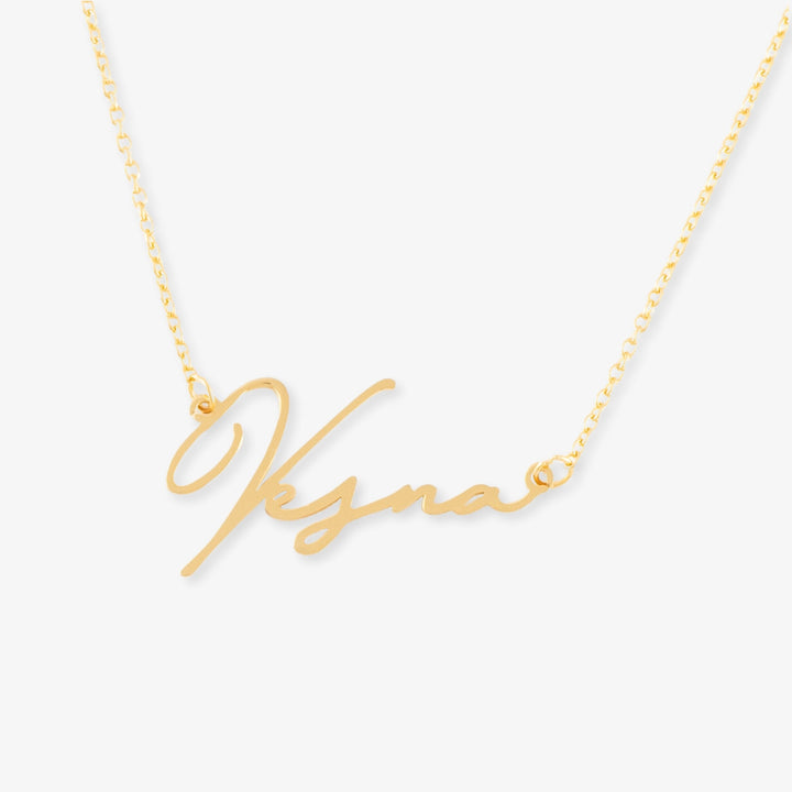 Gold name necklace with extravagant script, personalized with up to nine letters, made of 925 Sterling Silver.