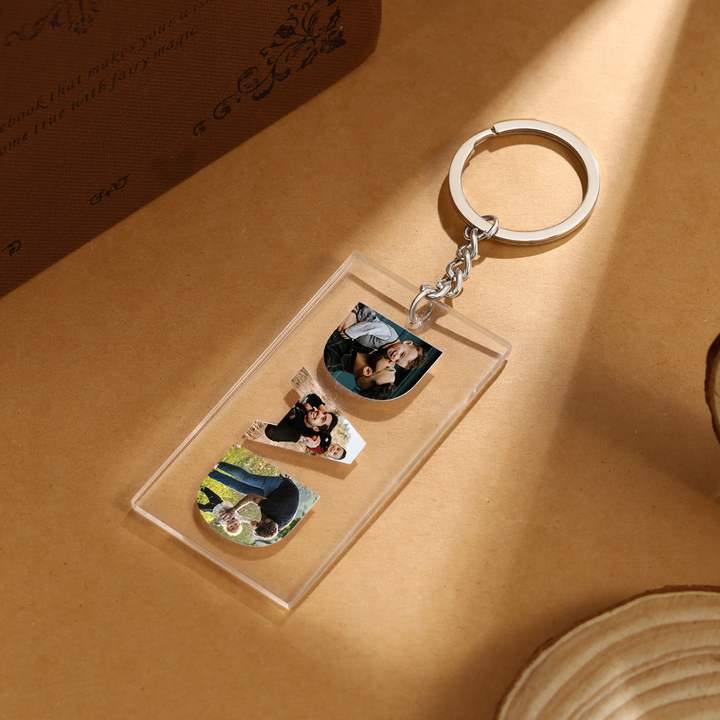 Custom 'DAD' acrylic photo keychain with personalized white picture charms for fathers featuring three unique photos