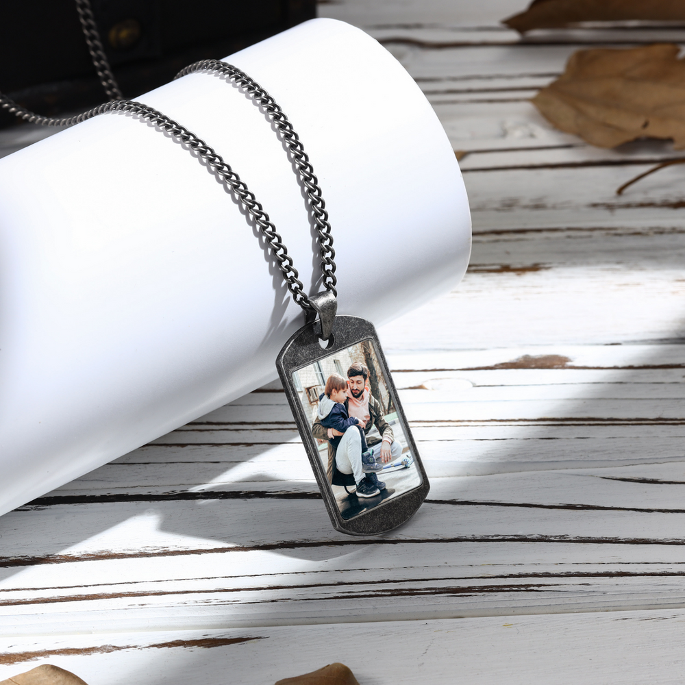 Custom photo engraved dark grey stainless steel men's necklace with personalized acrylic color pendant featuring two people.