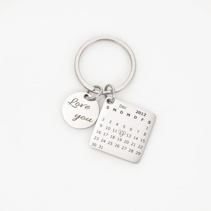 Personalized calendar keychain with engraving, featuring a heart-marked date and round charm saying "Love you" for unique memories.