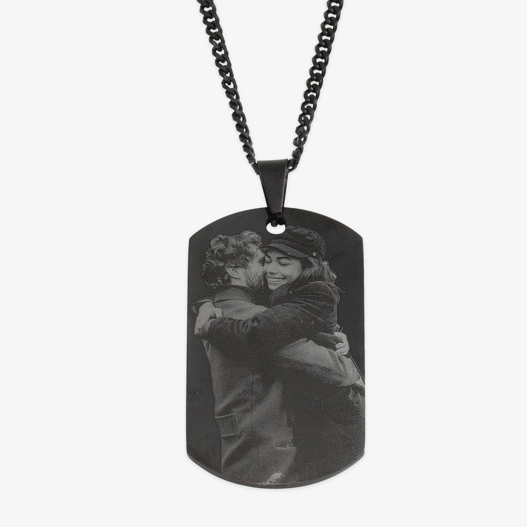 Men's black photo necklace with custom calendar pendant showing a couple hugging in an engraved photo