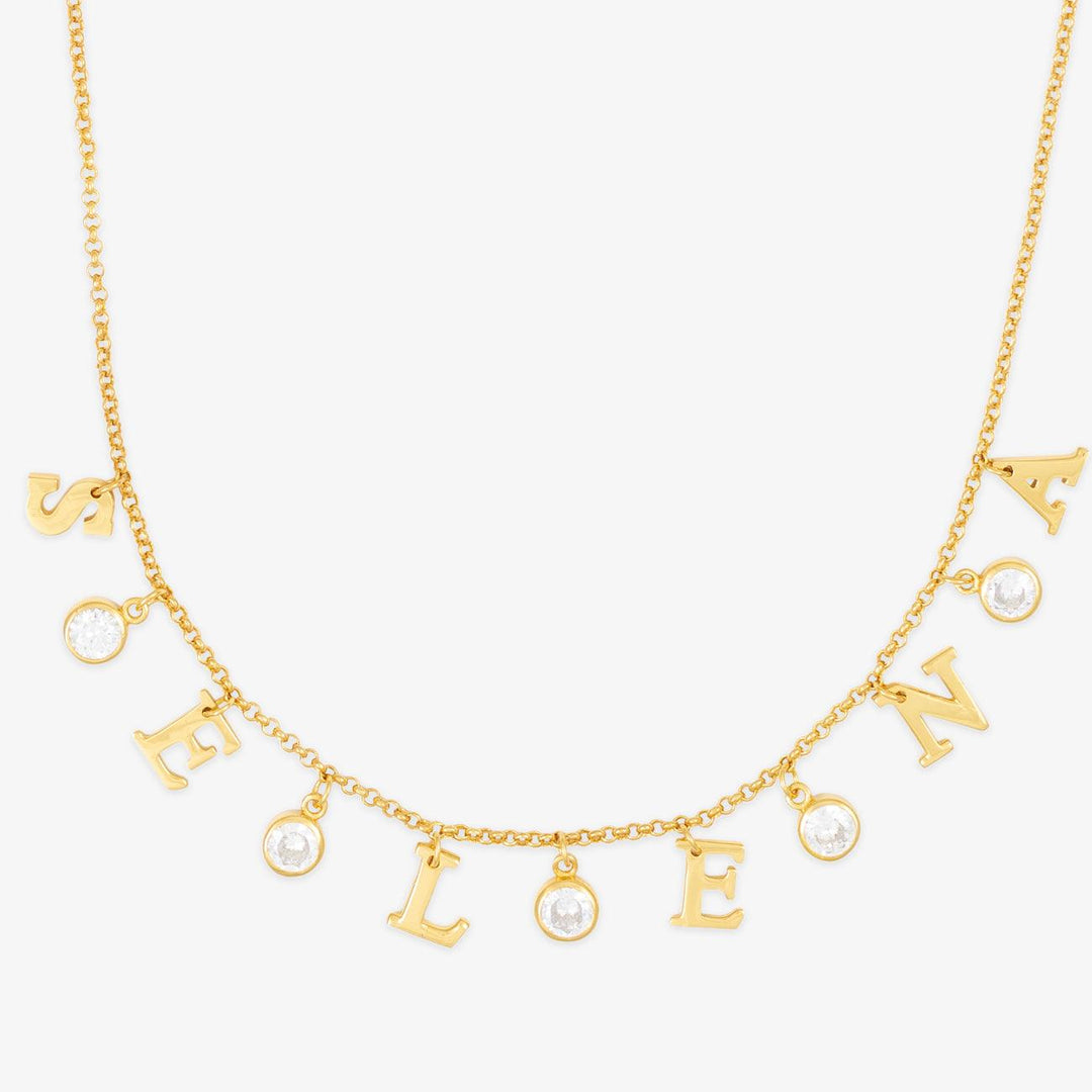 Elegant sterling silver initial necklace personalized with cubic zirconia stones spelling "SELENA" in gold.