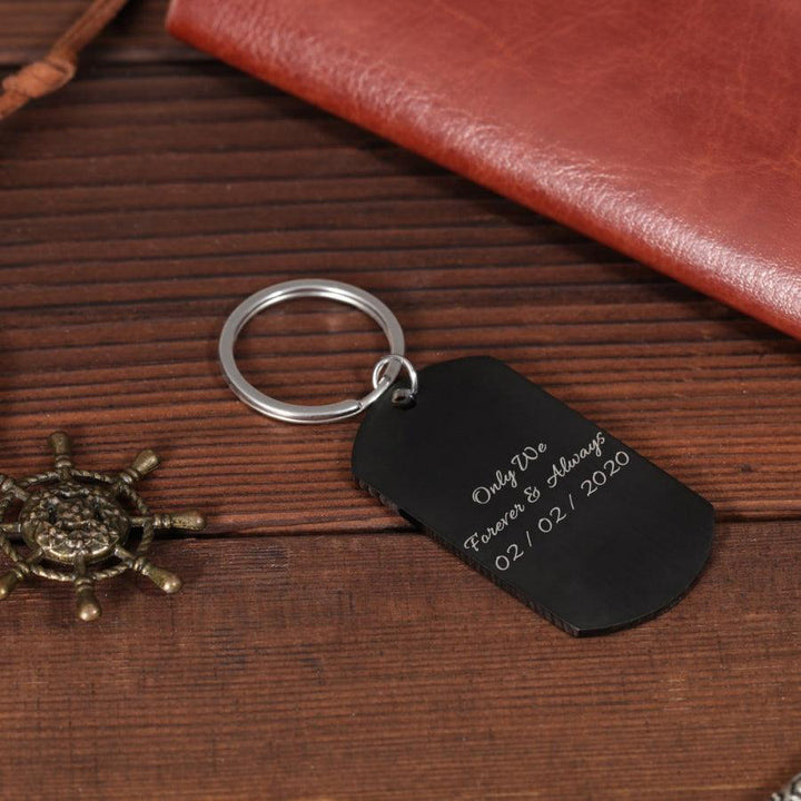 Personalized black photo and text keychain with custom engraving on wooden surface