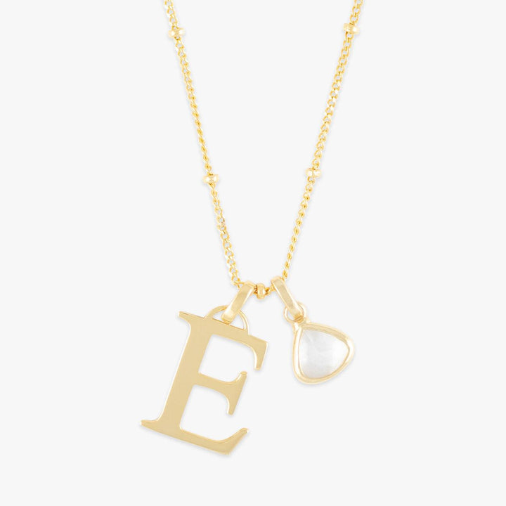 Personalized gold initial necklace with birthstone pendant, featuring a letter "E" and a matching birthstone charm.