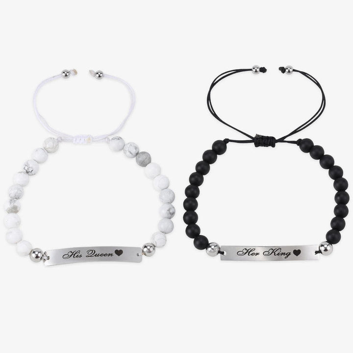 Personalized pearl couple bracelets set with "His Queen" and "Her King" charms, one in white and the other in black, symbolizing love and unity