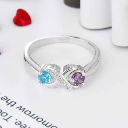 Personalized Infinity Sterling Silver Ring with Birthstones on white surface