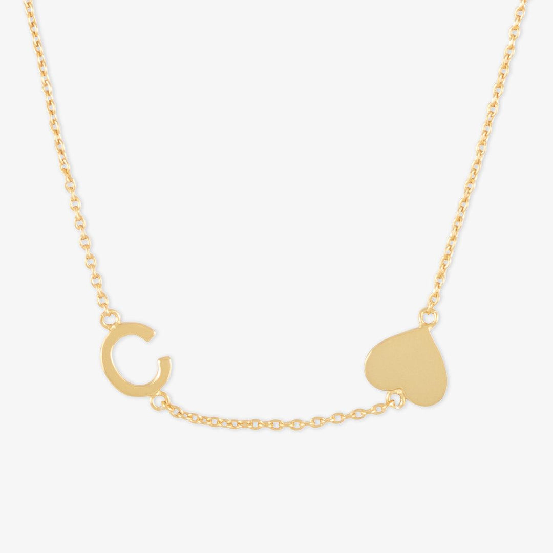 Gold 18K plated sideways letter necklace with a heart charm in 925 sterling silver.