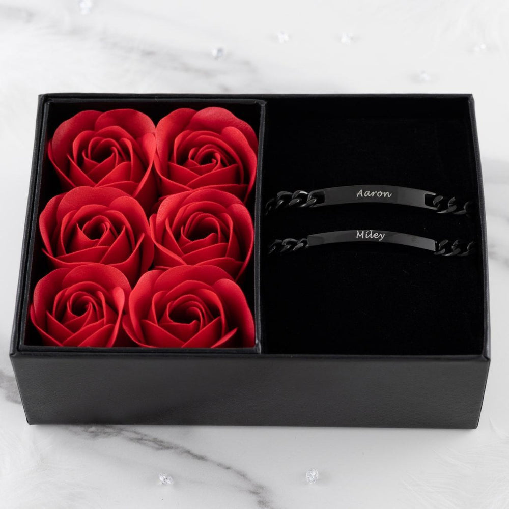 Personalized black couple bracelets set with red roses in a gift box - symbol of lasting love and commitment.