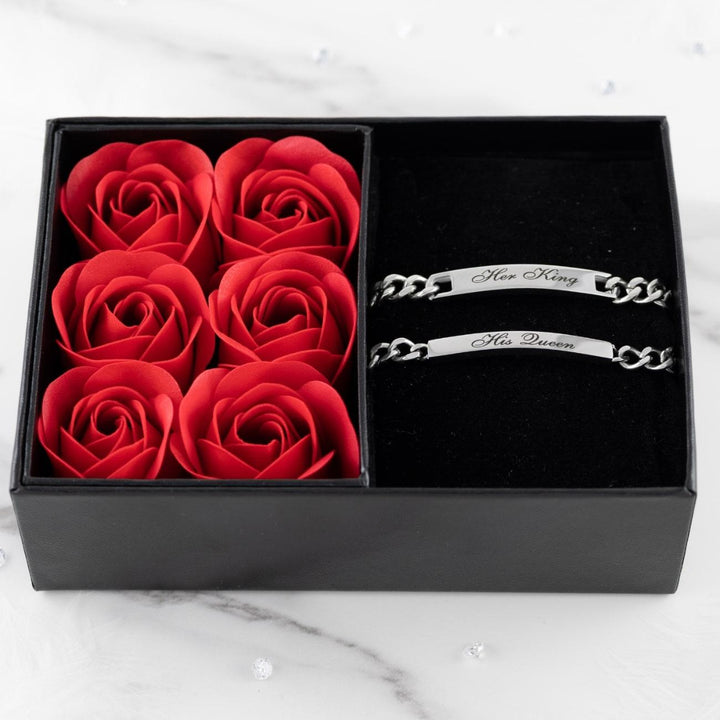 Personalized couples bracelet set with engraved "His Queen" and "Her King" bracelets, in a black box with red roses.